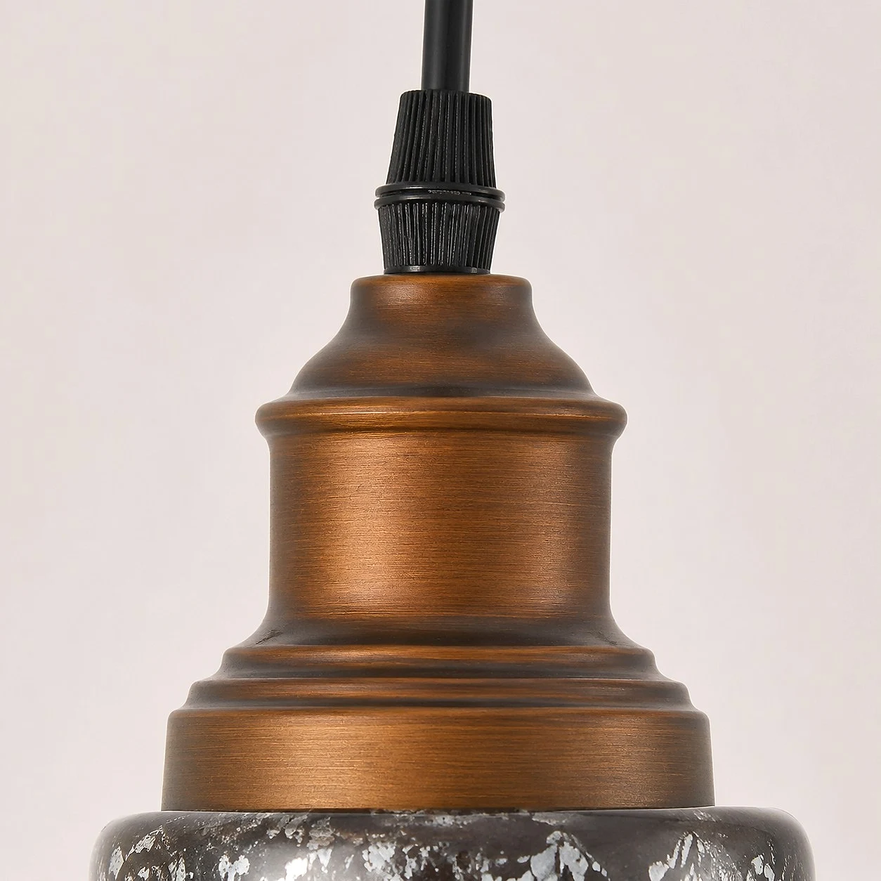 Close detail of brushed bronze metal cap and cord grip