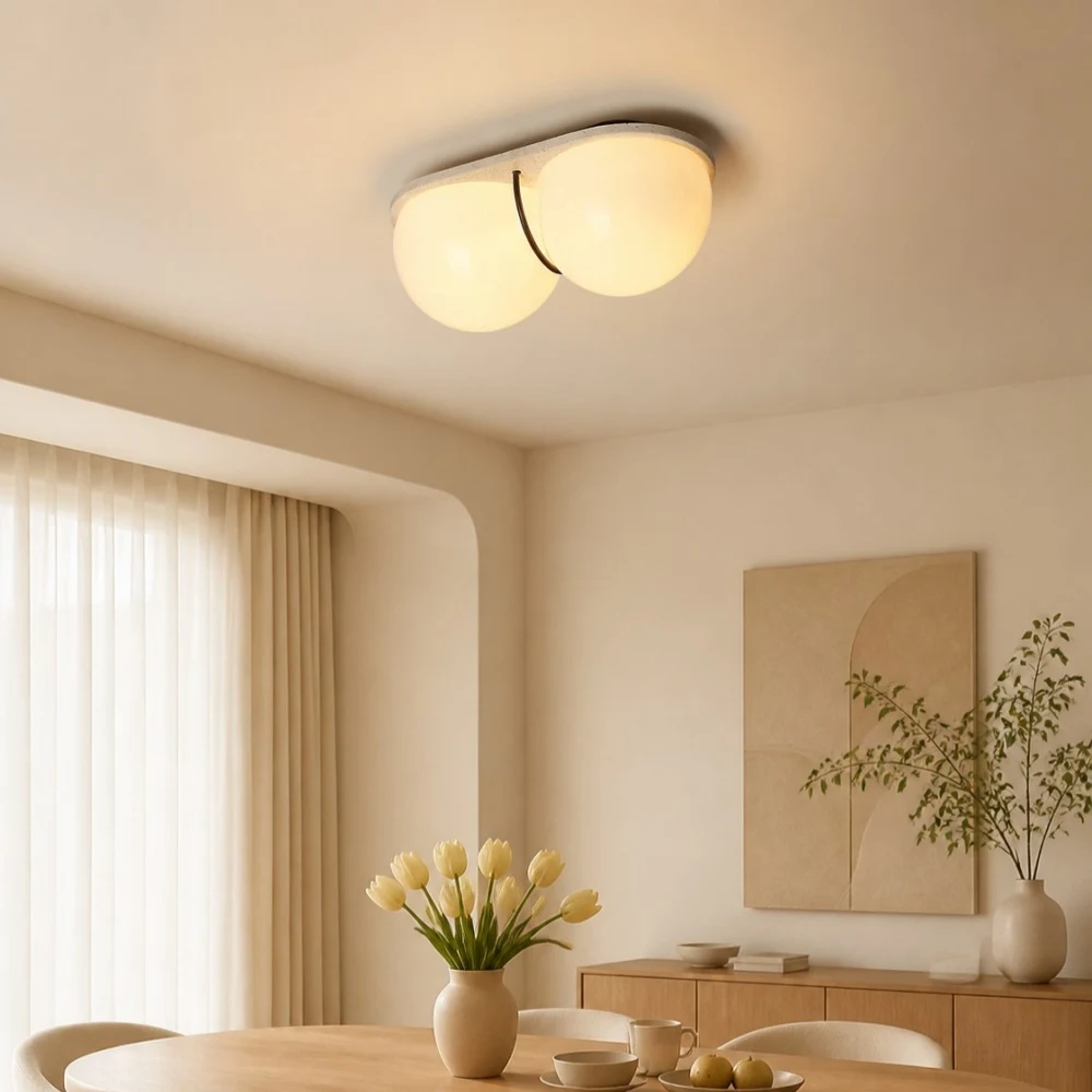 Cream travertine ceiling lamp above a dining table
