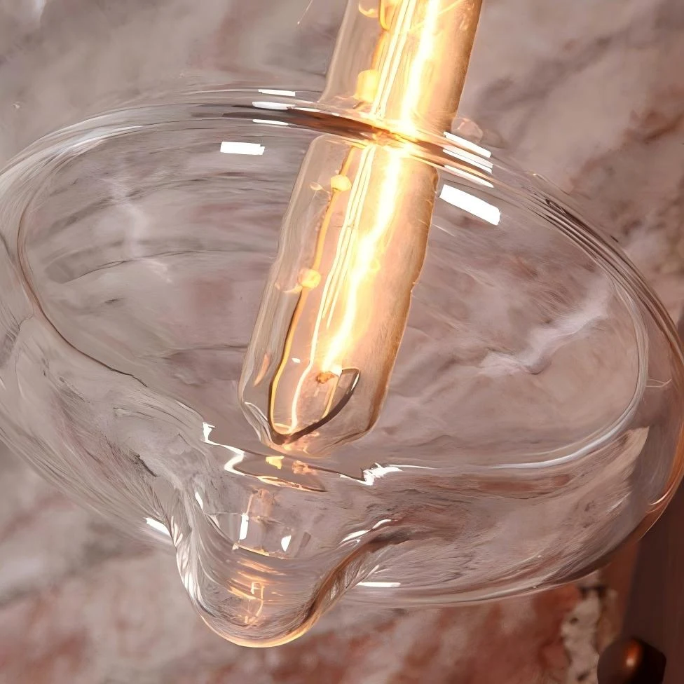 Close view of the clear glass shade and warm bulb glow