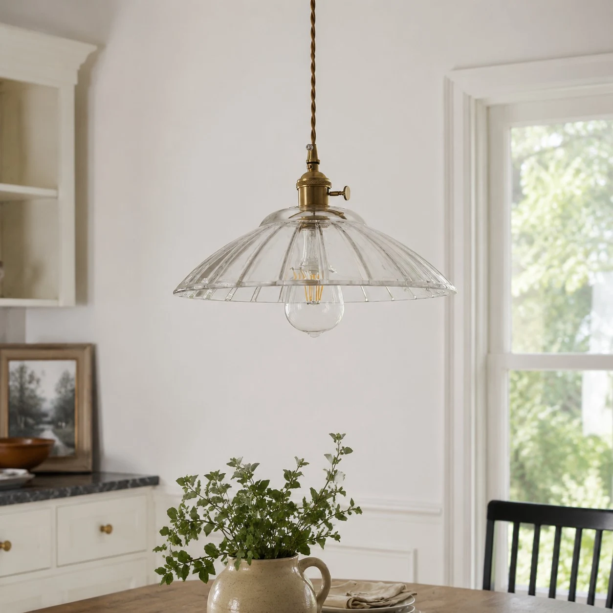 Transparent glass pendant installed over a dining table
