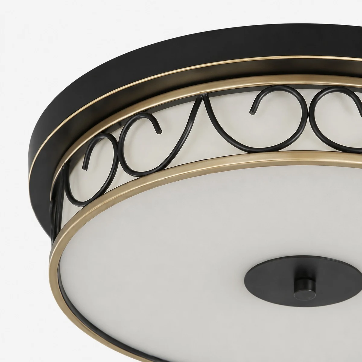 Close-up of black rim and decorative scrollwork band