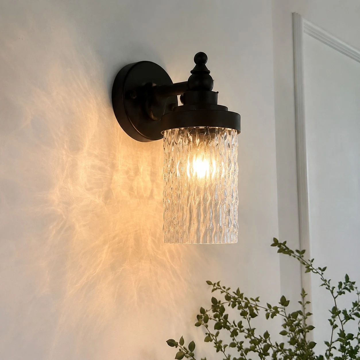 Wall sconce casting warm light in a hallway corner