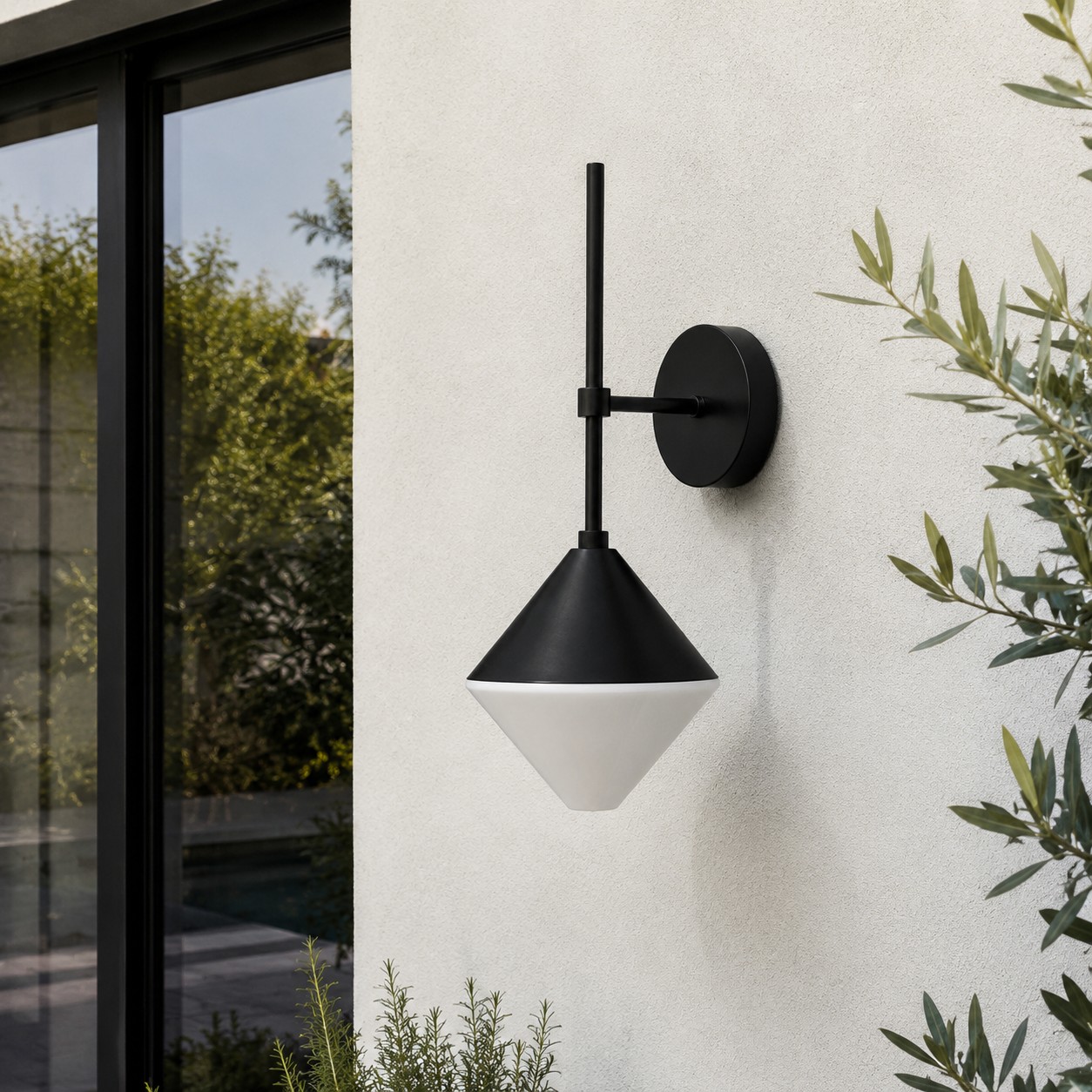 black and white outdoor wall sconce mounted on a garden exterior wall