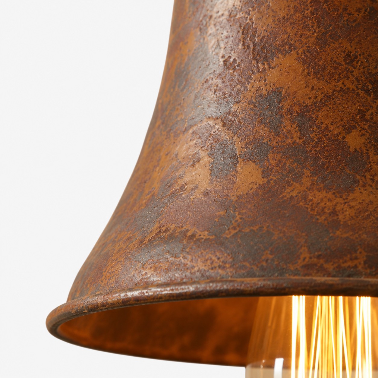 Close-up of weathered rust metal texture on pendant shade