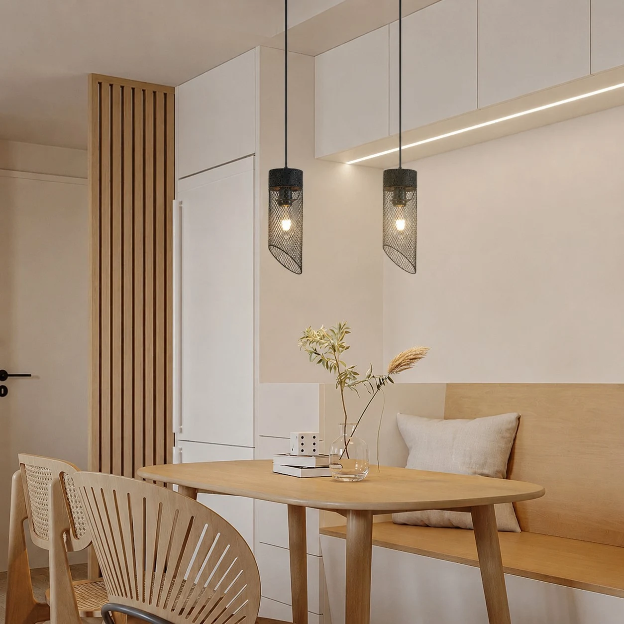 Pair of black mesh pendant lights installed over a cafe table