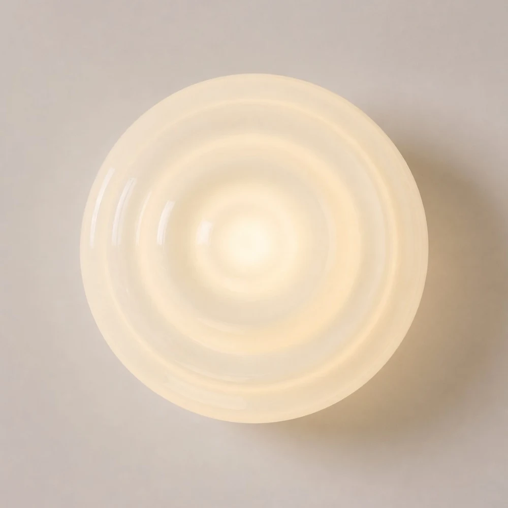 Warm glowing ribbed glass wall lamp front detail