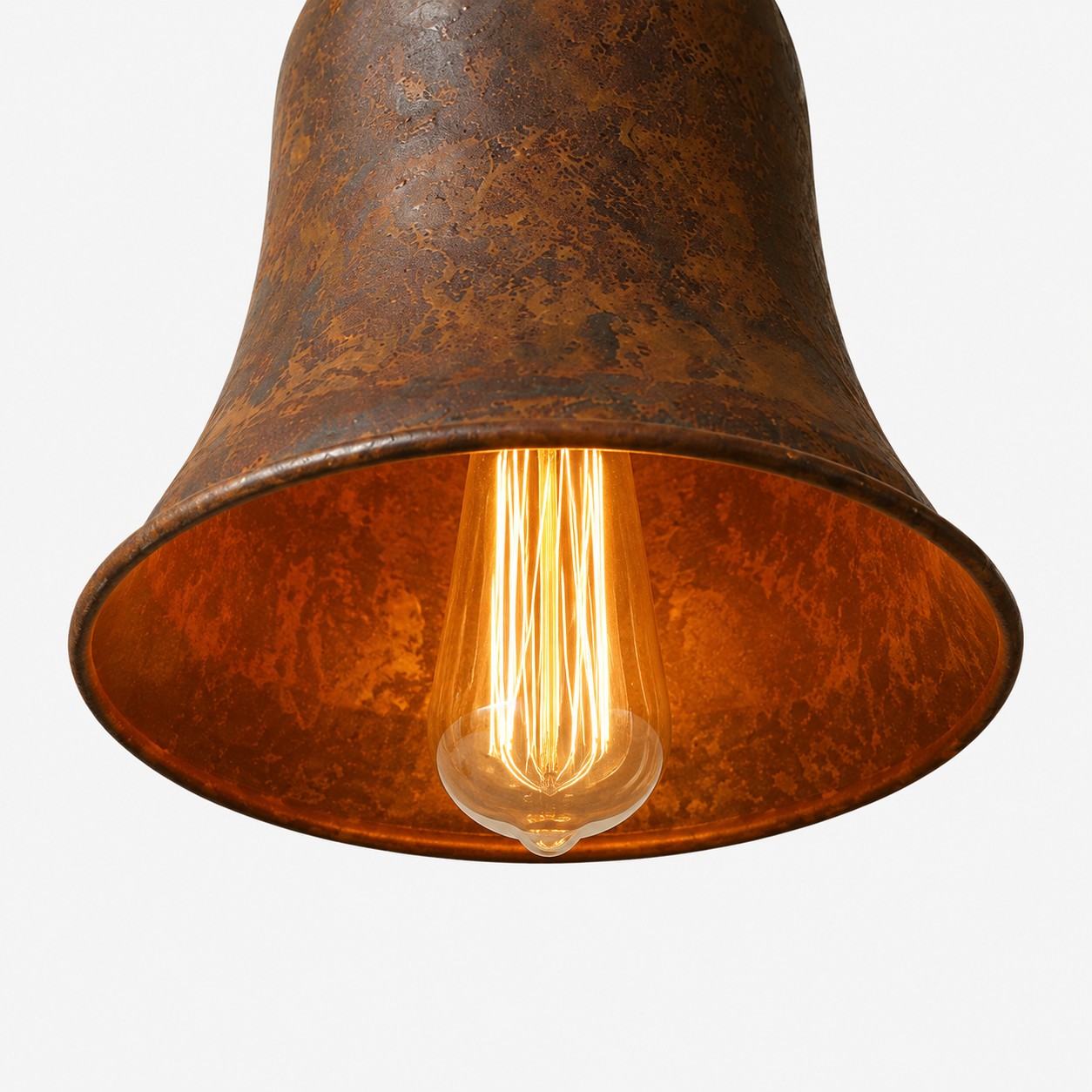 Warm bulb glow below rust metal pendant shade