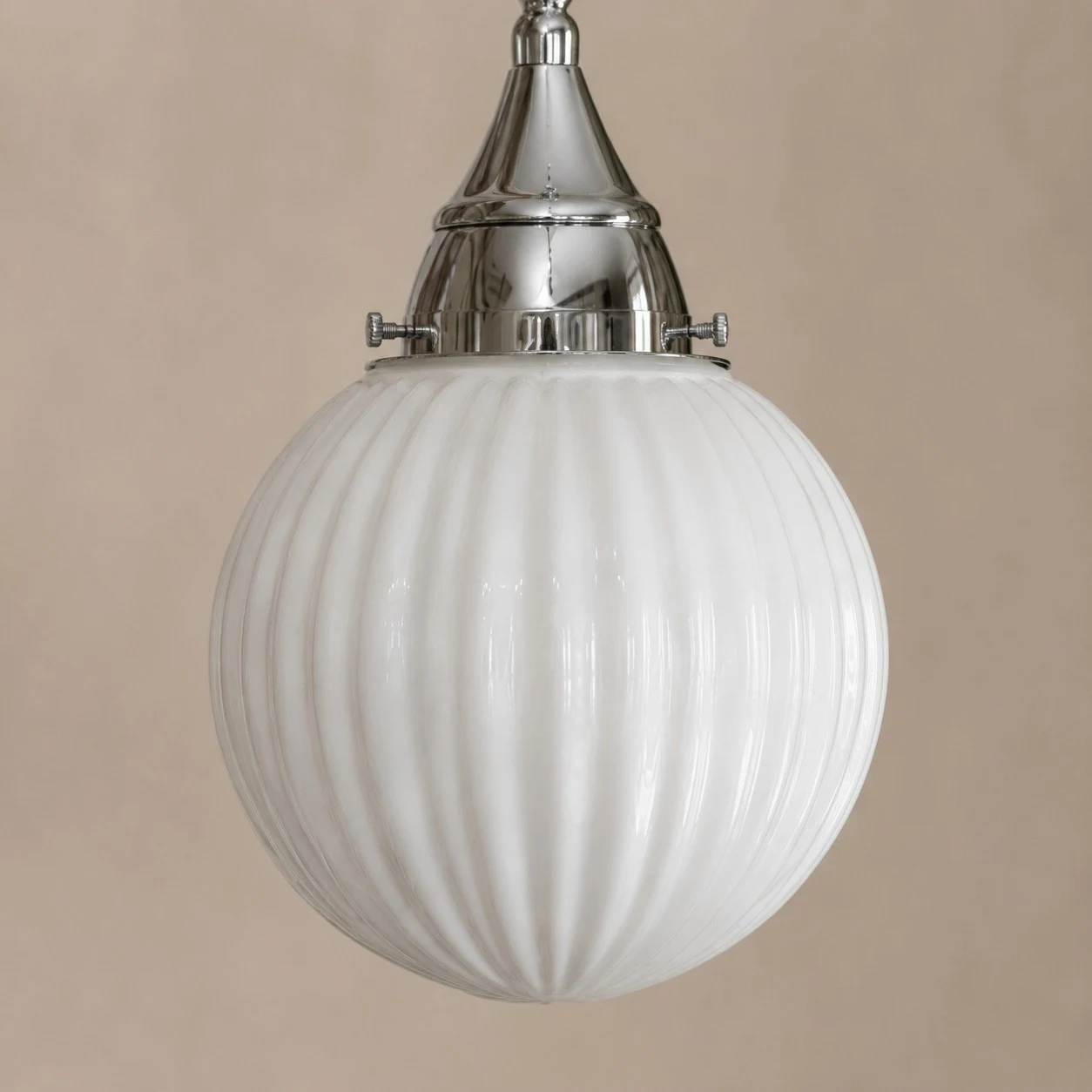 Close view of ribbed glass shade and metal cap
