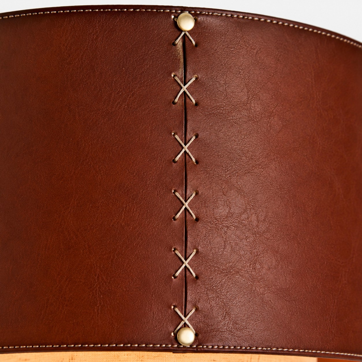 Close-up of brown leather drum shade stitching detail