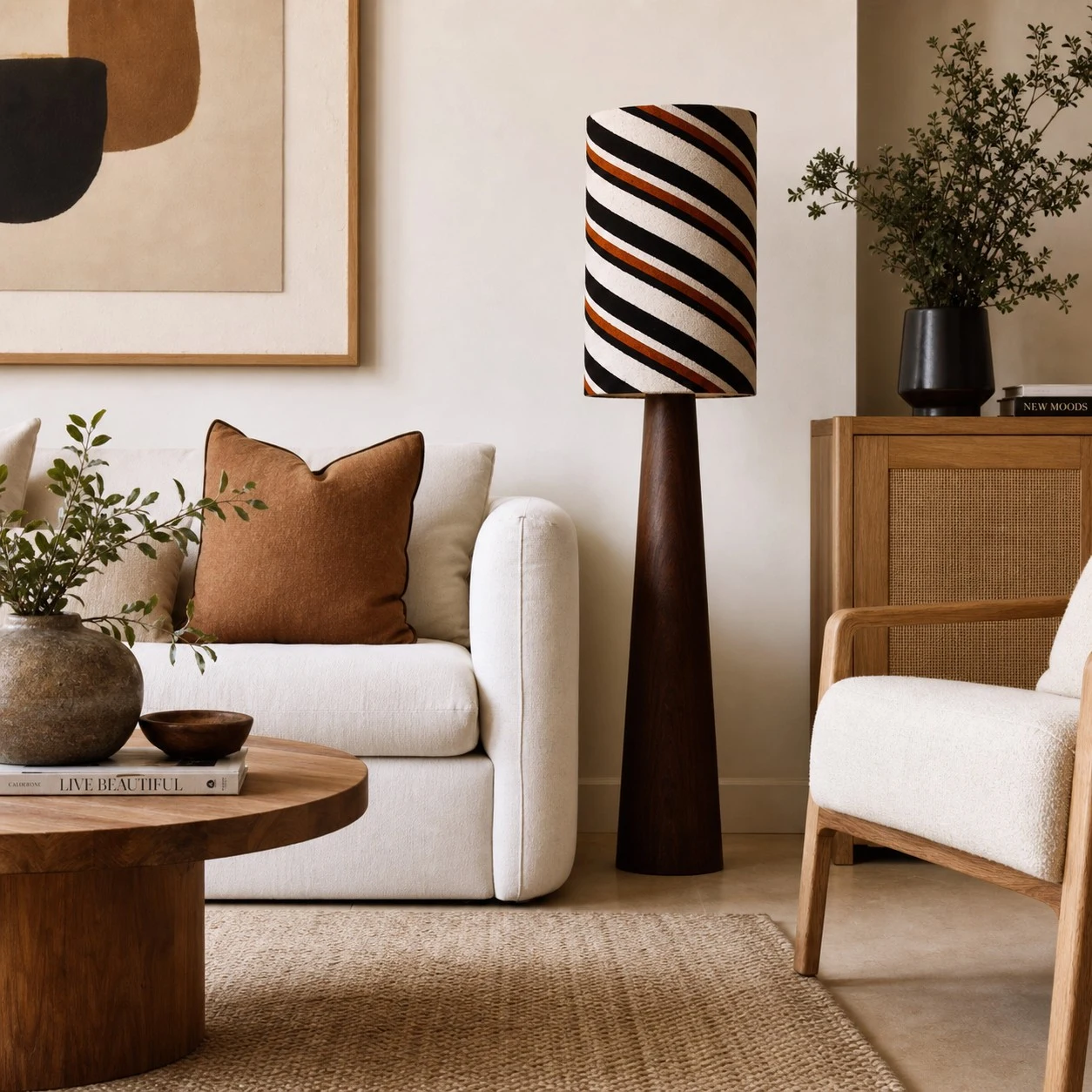 Striped floor lamp in a cozy reading corner with chair and art wall