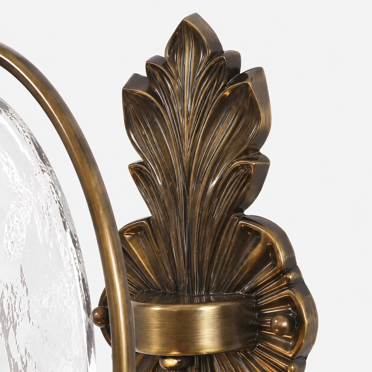 Close view of sculpted antique brass leaf backplate detail