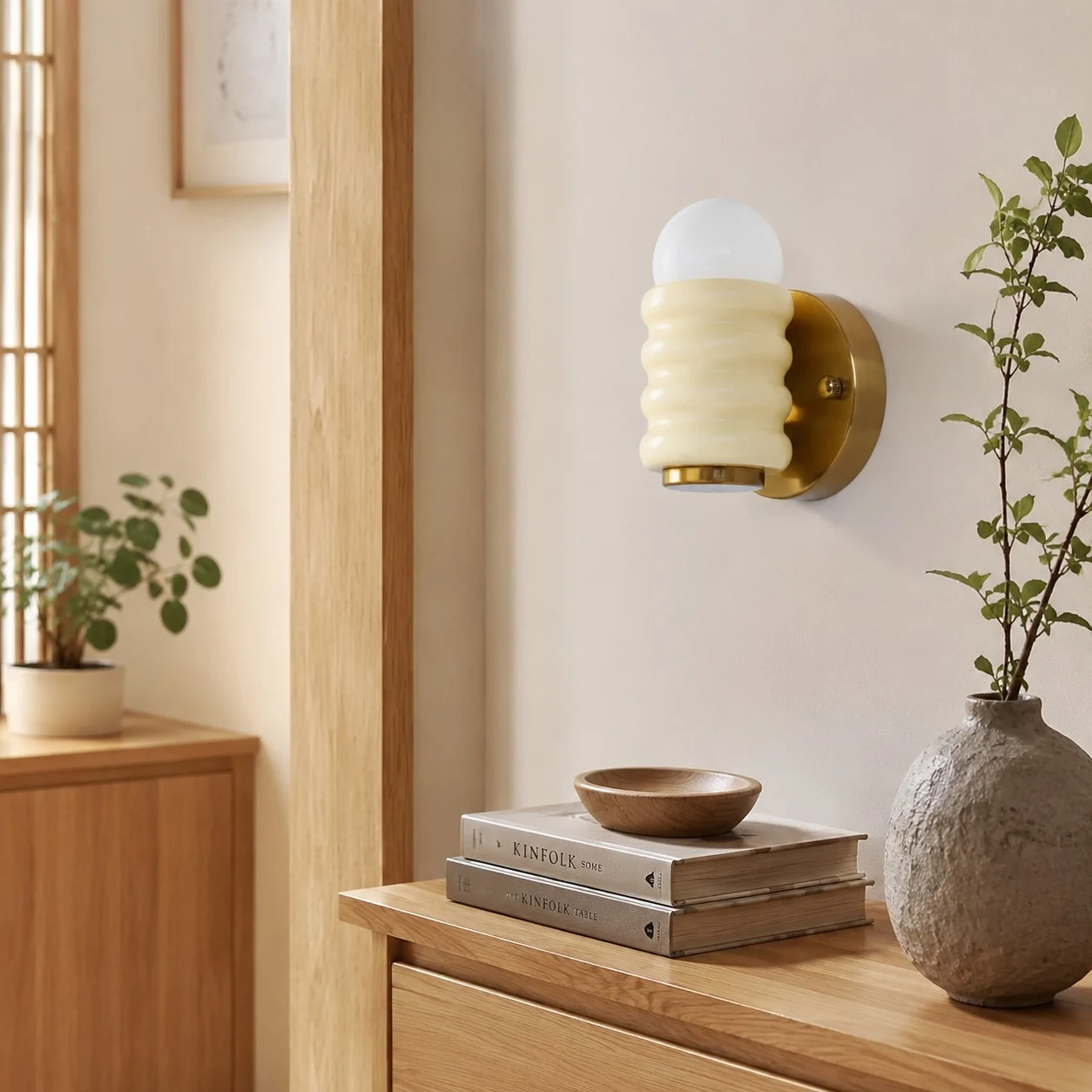 Cream wall sconce above console table