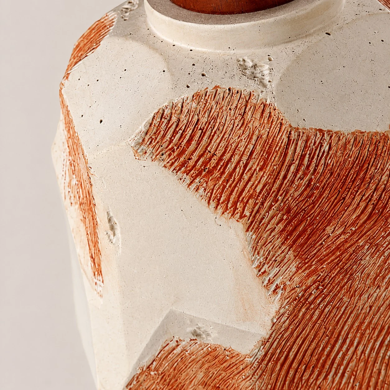 Microcement-like pitted surface and hand-ridged terracotta texture