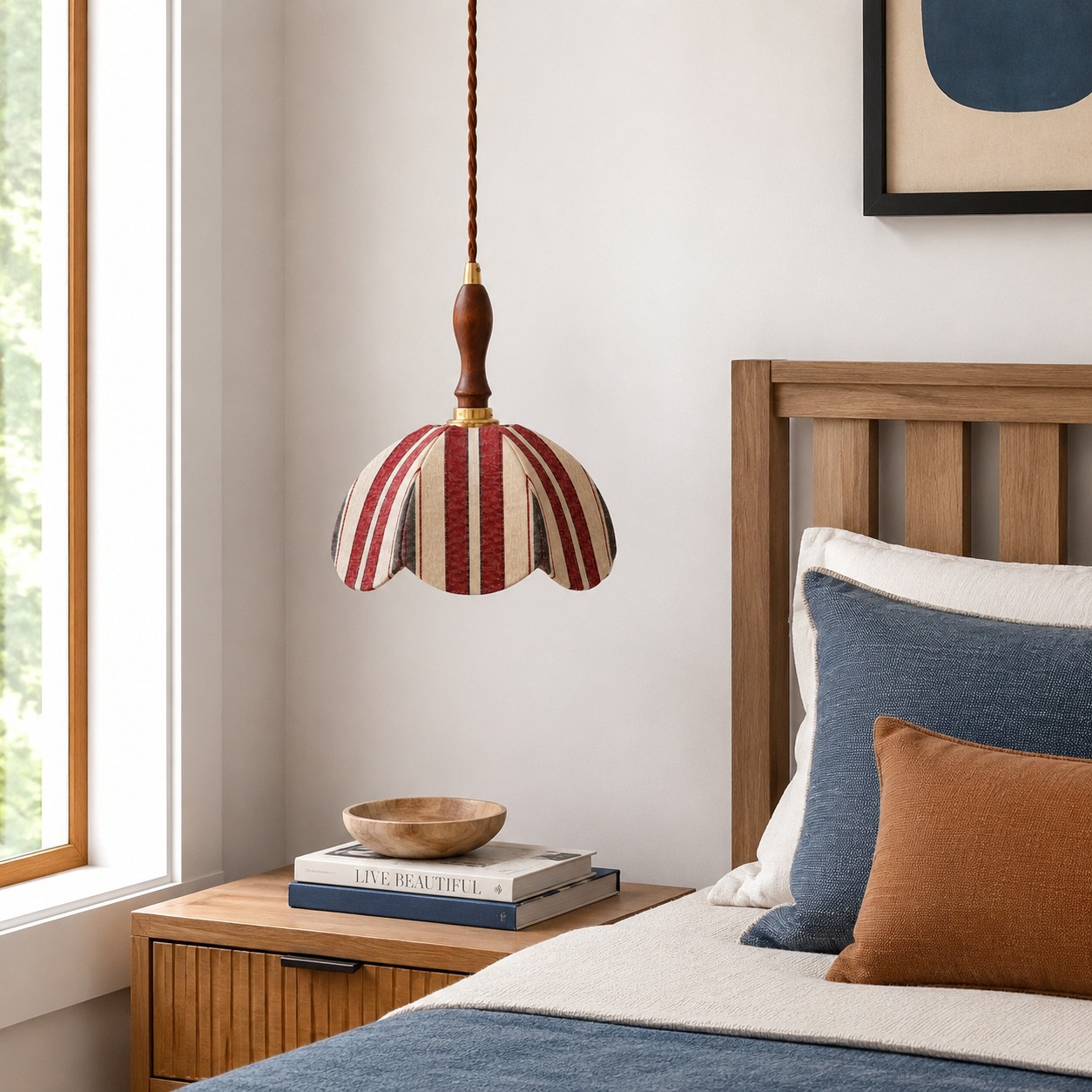 Red and ivory striped fabric pendant lamp installed beside a bed