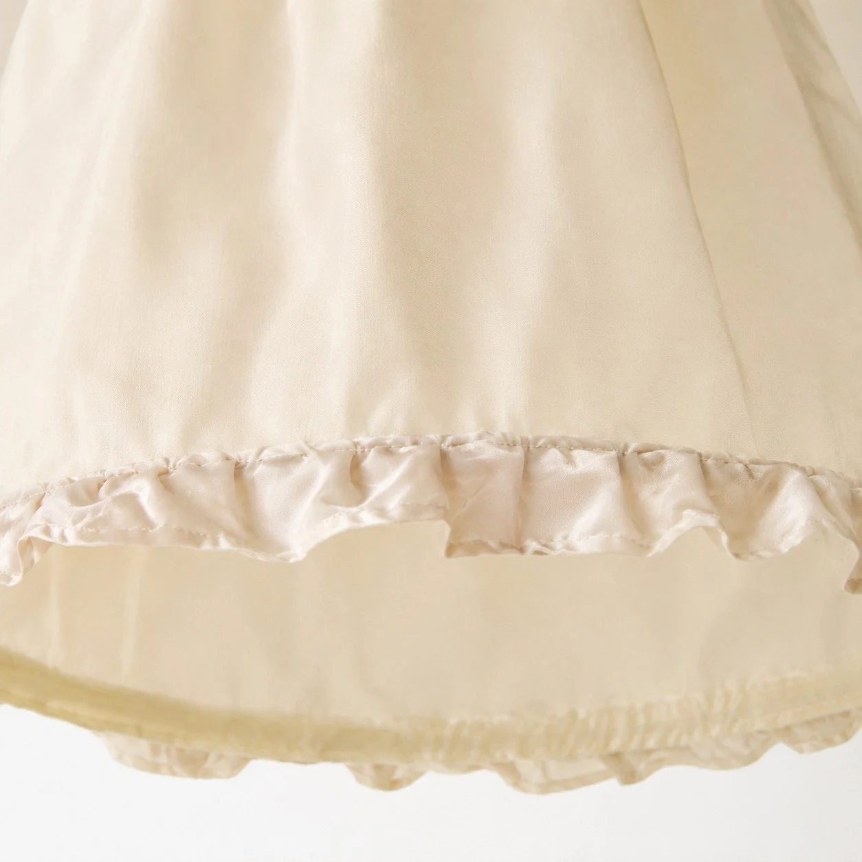 Close view of the softly ruffled fabric shade edge